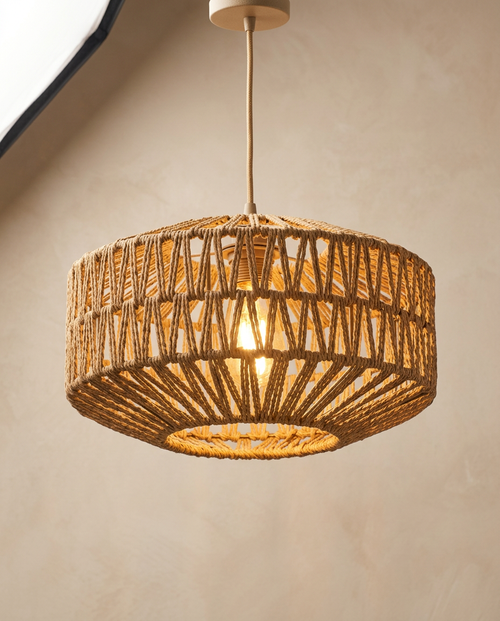 Natural woven rattan rope basket pendant light glowing warm, Pale Meridian